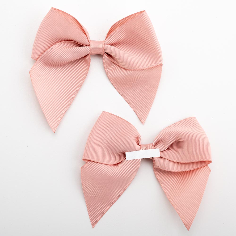 Front and back of rose gold 10cm grosgrain bow showing the self-adhesive strip