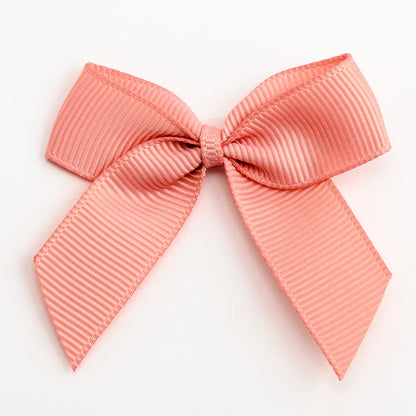 Rose Gold 5cm self-adhesive grosgrain ribbon bow on a white background