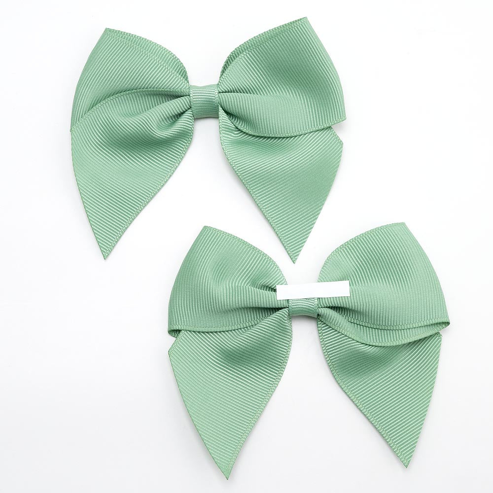 Front and back of sage green 10cm grosgrain bow showing the self-adhesive strip