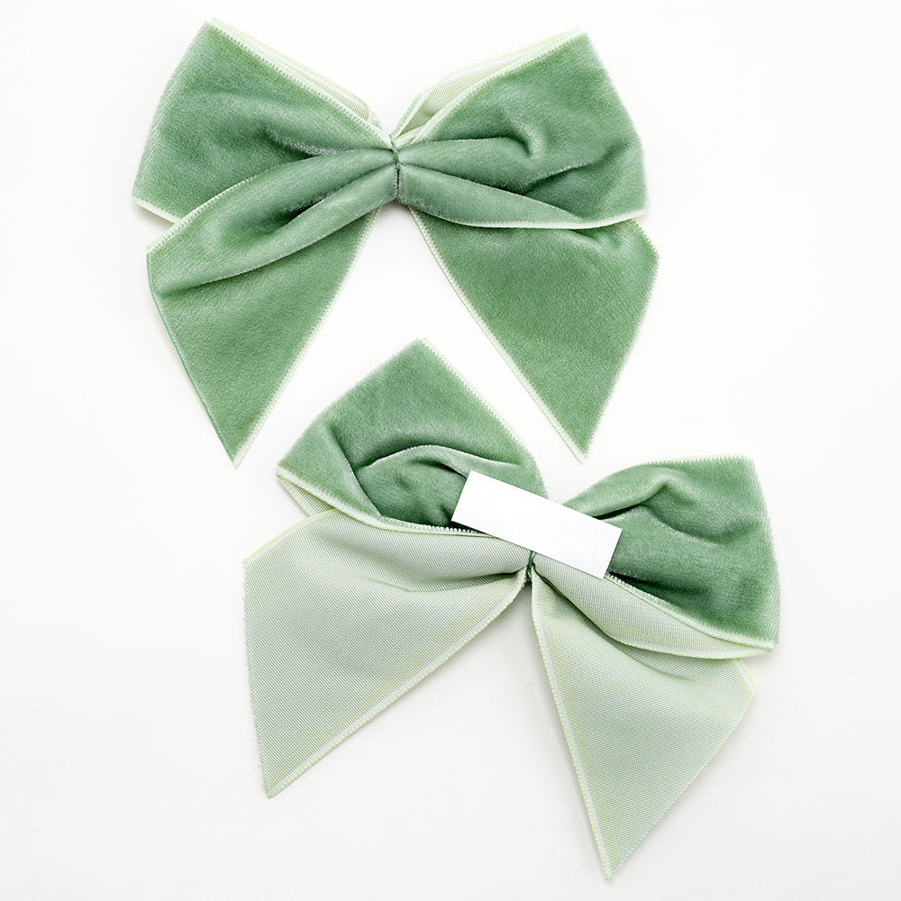 Front and back of sage green 10cm velvet bows showing the self-adhesive strip