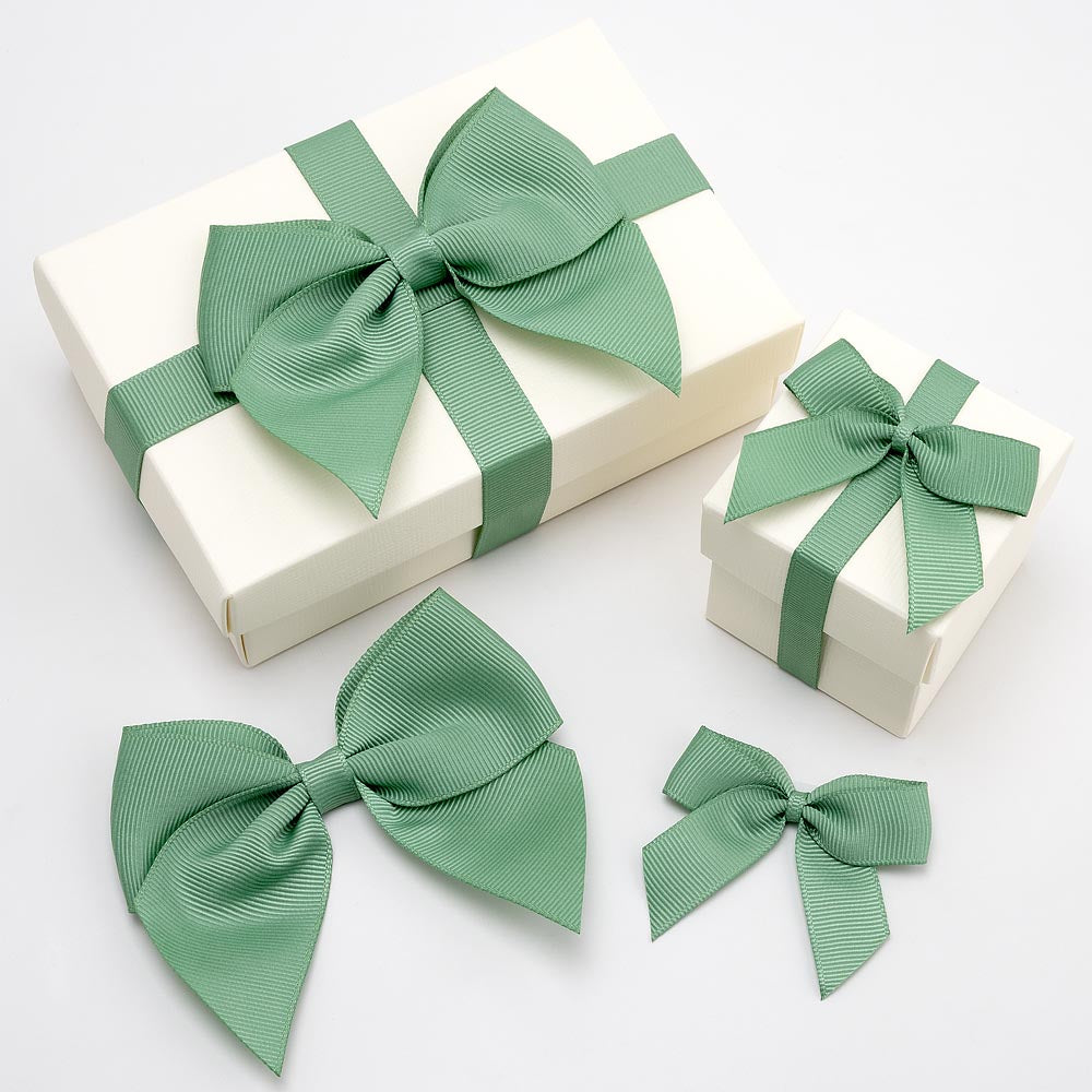 Sage green grosgrain ribbon bows in different sizes with wrapped gift boxes