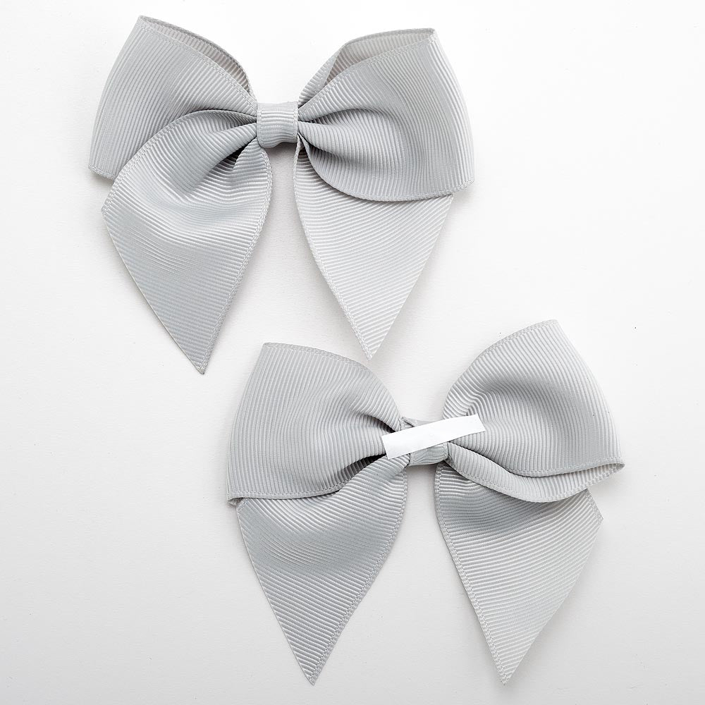 Front and back of silver 10cm grosgrain bow showing the self-adhesive strip