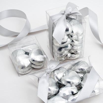 Silver chocolate heart wedding favours displayed in a gift box