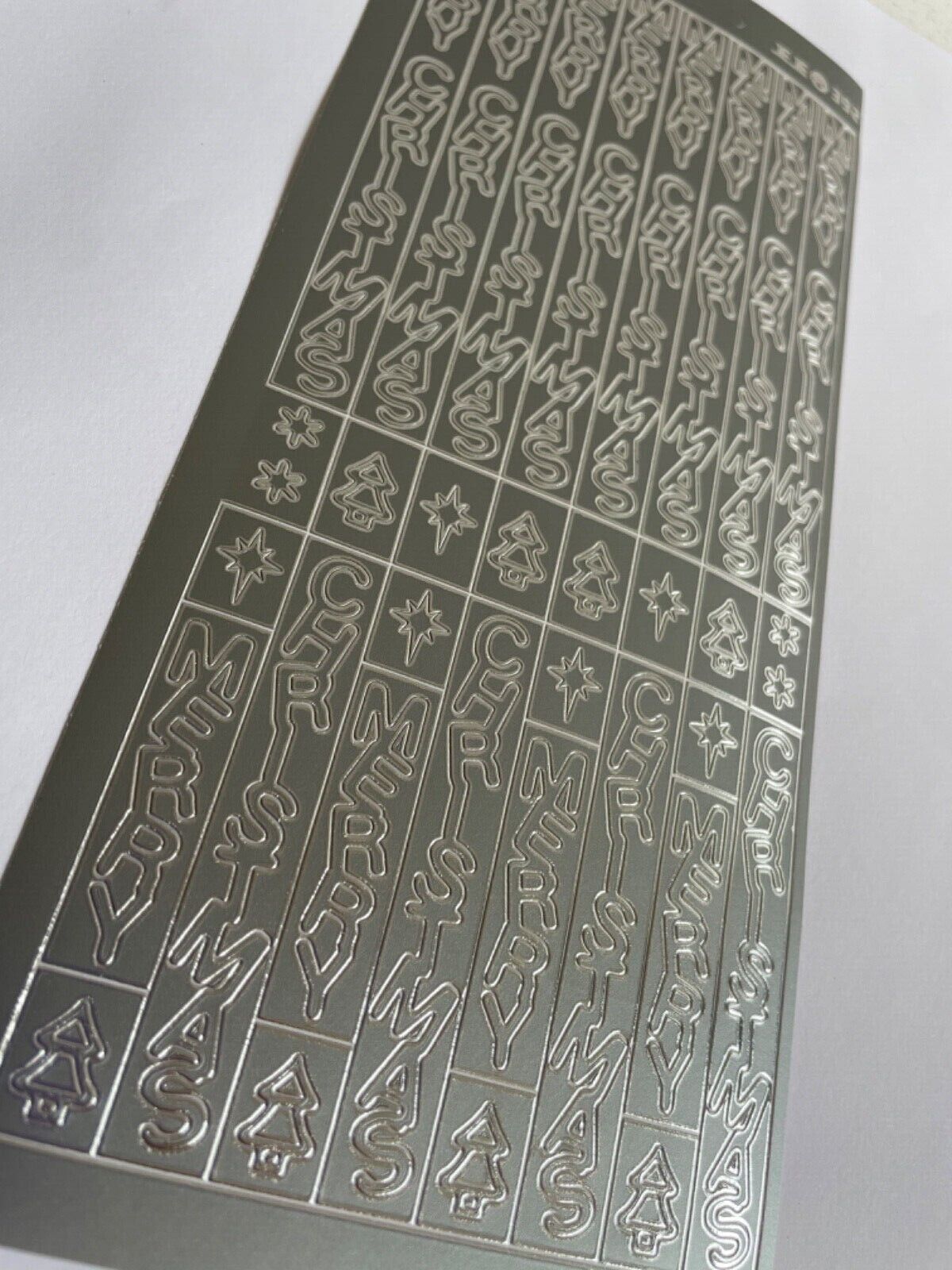Close-up of silver vertical Merry Christmas peel off stickers