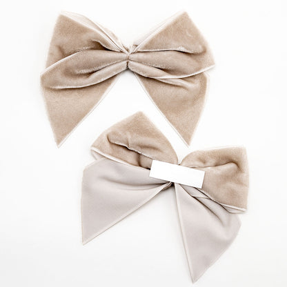 Front and back of taupe 10cm velvet bows showing the self-adhesive strip