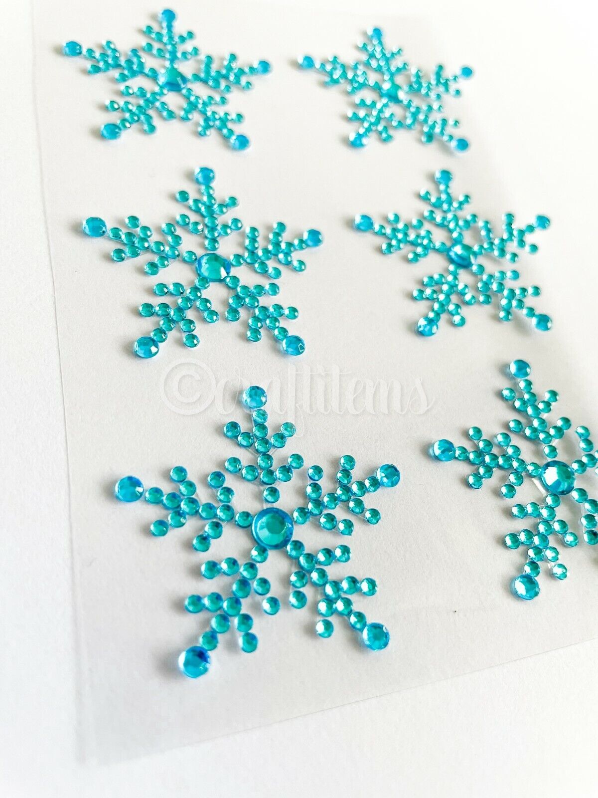 Close up of turquoise self adhesive snowflake stickers for christmas cards