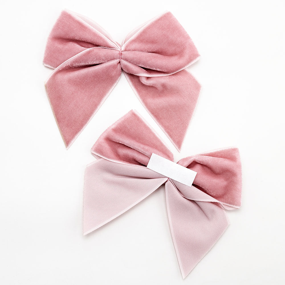 Front and back of vintage pink 10cm velvet bows showing the self-adhesive strip