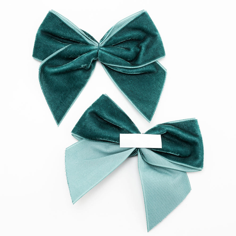 Front and back of vintage teal 10cm velvet bows showing the self-adhesive strip