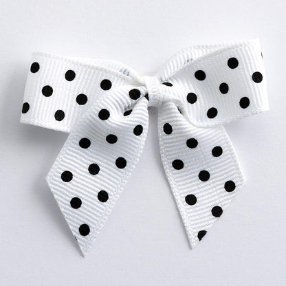 White 5cm polka dot grosgrain ribbon bow on a white background