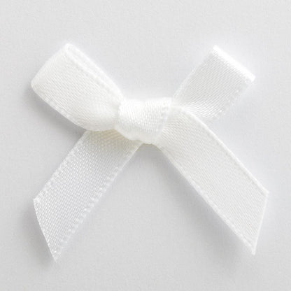 White mini satin ribbon bow made from 6mm ribbon, approximately 3cm wide