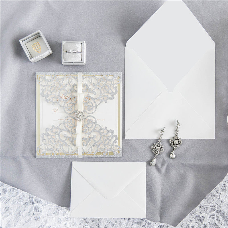 Silver glitter wedding invitation and white envelopes