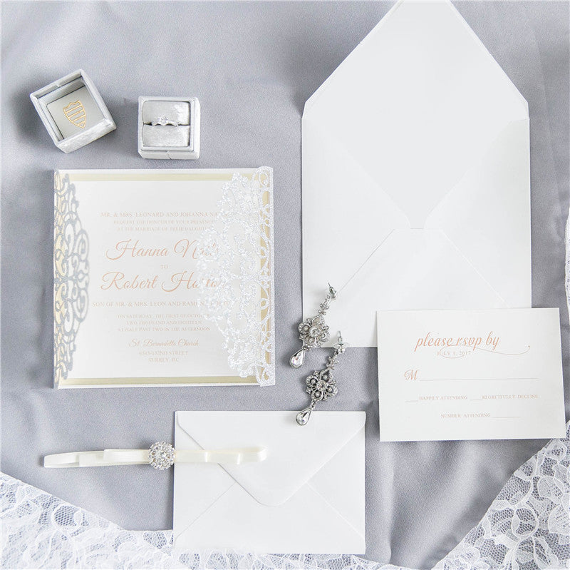 Open wedding invitation with silver glitter, white ribbon and diamante detail