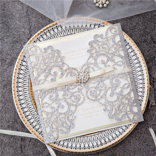 Silver glitter gatefold laser cut lace wedding invitation with ribbon belly band and diamante jewel