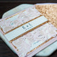 Close up of rose gold glitter and blush pink lace wedding invitation