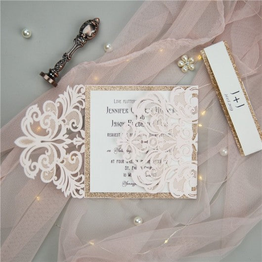 open pale pink laser cut lace wedding invitation with rose gold accent