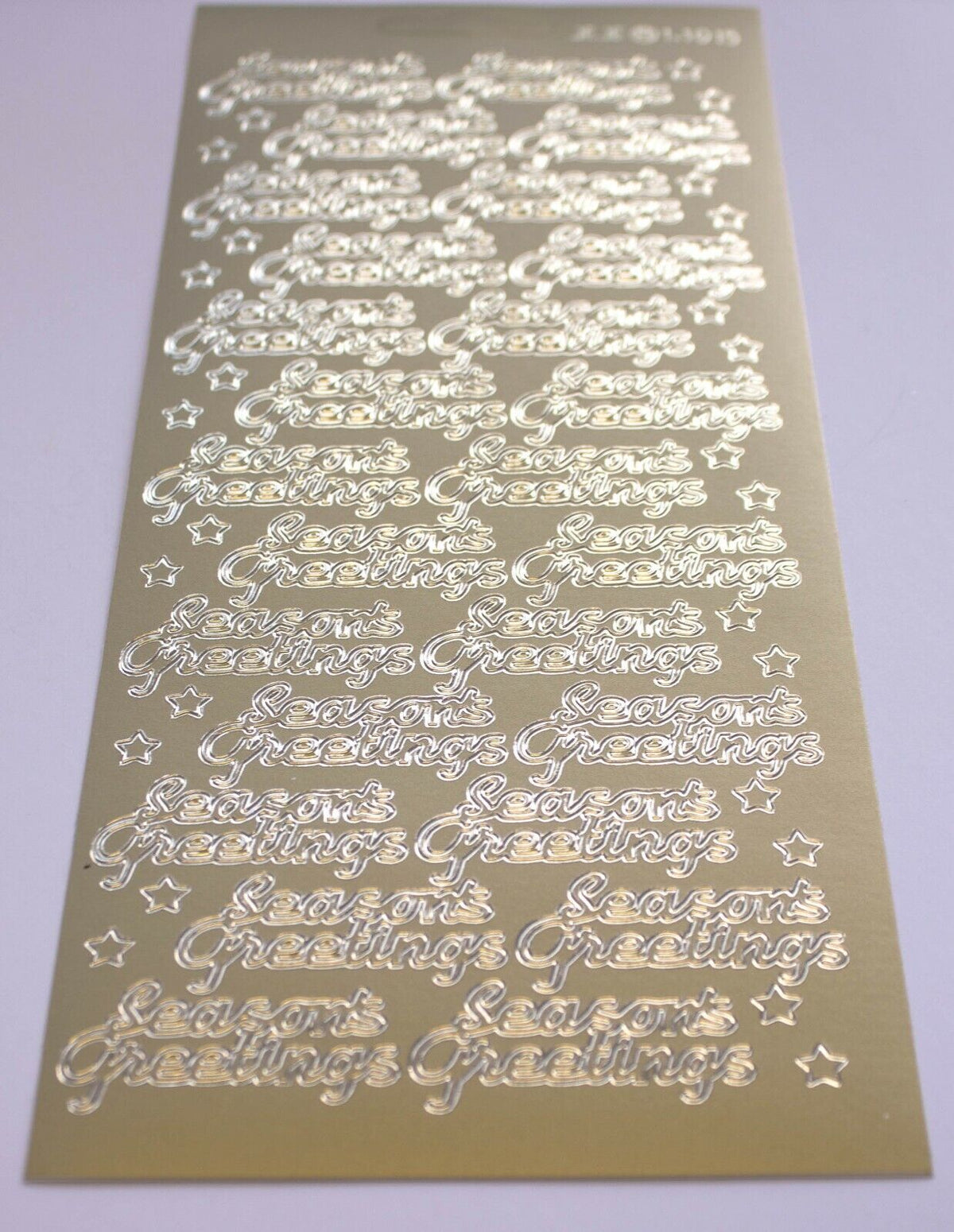 A close up of gold seasons greetings christmas stickers for card making