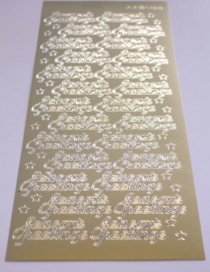 A close up of gold seasons greetings christmas stickers for card making